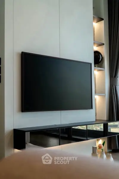 Modern living room with sleek TV setup and elegant shelving