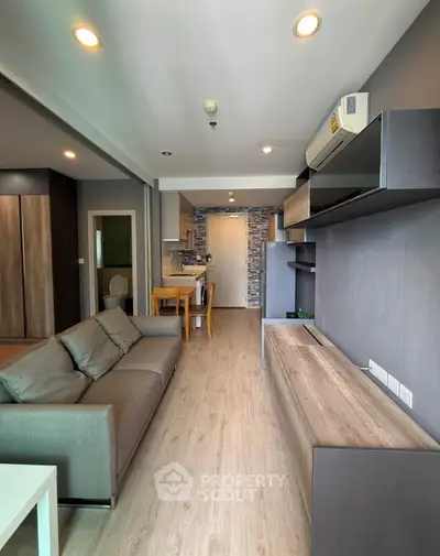 Modern living room with sleek furniture and open kitchen layout