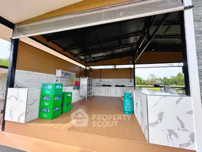 Spacious outdoor kitchen with marble countertops and ample storage, perfect for entertaining and culinary adventures.