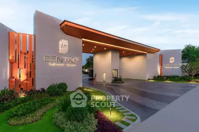 Modern luxury apartment entrance with sleek design and lush landscaping