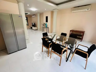 Spacious modern living room with dining area and sleek appliances