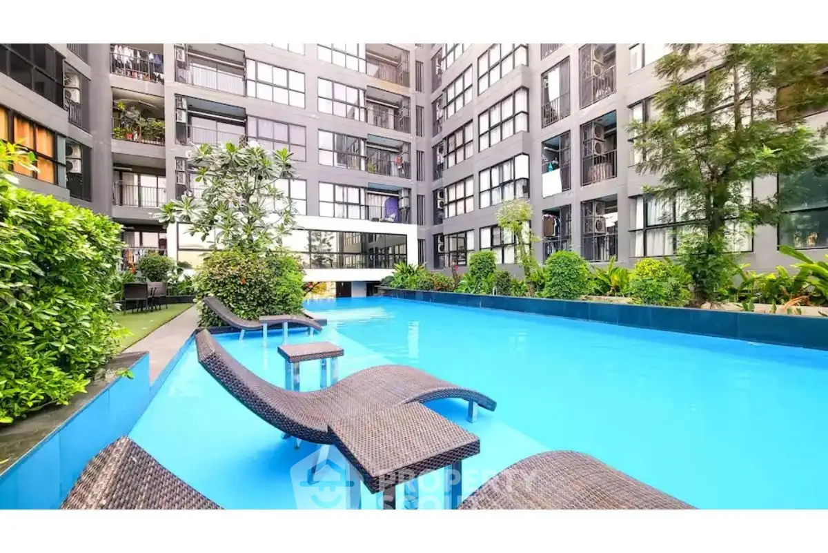 Luxurious apartment complex with inviting pool and lush greenery