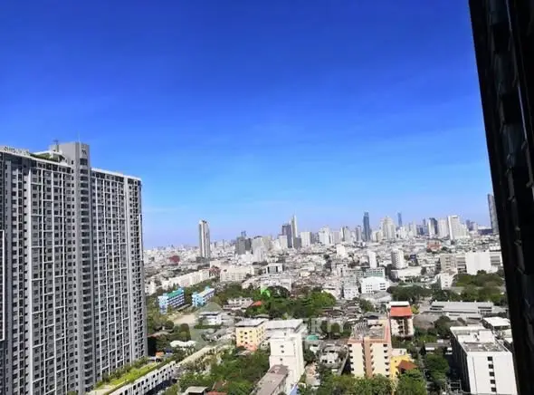 Stunning cityscape view from high-rise apartment balcony showcasing urban skyline.