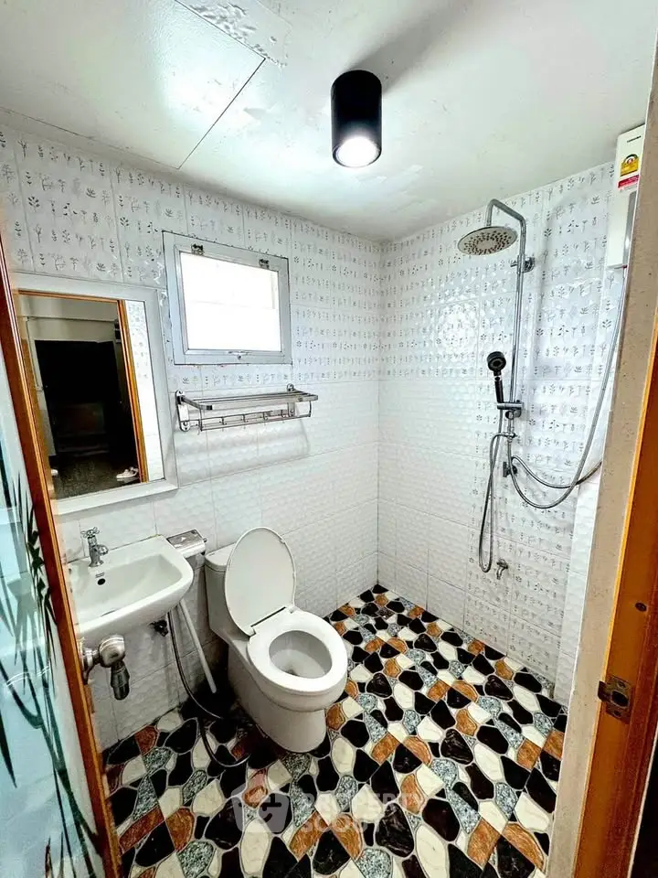 Modern bathroom with unique patterned tiles and rainfall showerhead