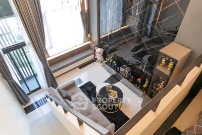 Luxurious living room with high ceiling and elegant decor