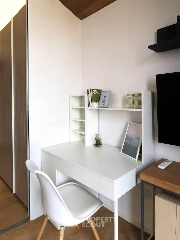 Modern study nook with sleek white desk and chair, perfect for productivity in a stylish home.
