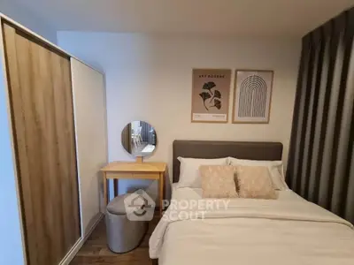 Cozy bedroom with modern decor, featuring a comfortable bed, stylish artwork, and a sleek wardrobe.