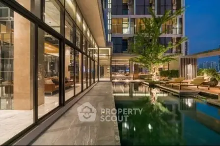 Luxurious modern building exterior with pool and elegant design.