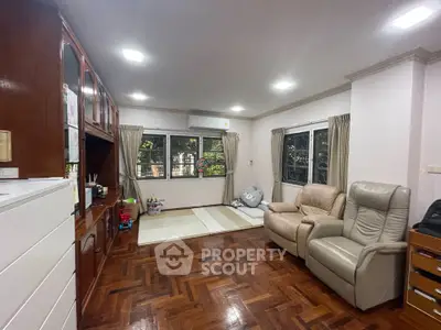 Spacious living room with parquet flooring and cozy seating area
