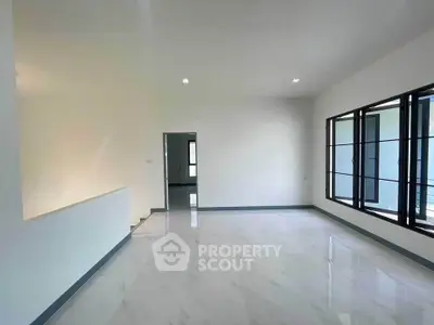 Spacious modern living room with large windows and sleek flooring