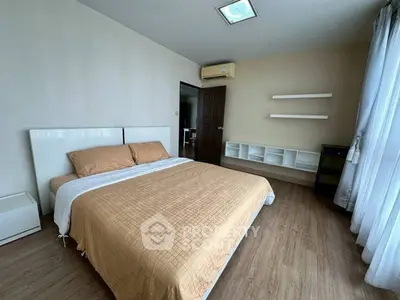 Spacious bedroom with modern decor and natural light