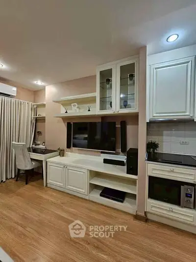 Charming living room with built-in shelves and modern appliances
