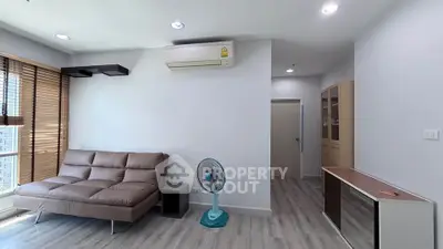 Modern living room with sleek furniture and air conditioning in a bright apartment.