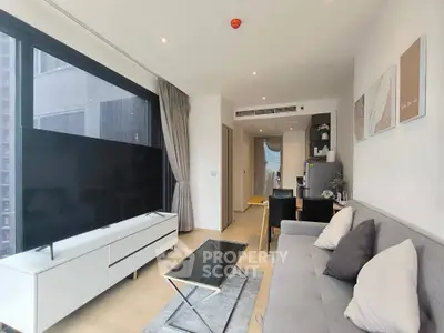 Modern living room with sleek furniture and large TV in a stylish apartment