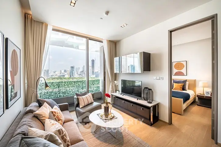 Modern living room with city view, stylish decor, and cozy seating area in a high-rise apartment.