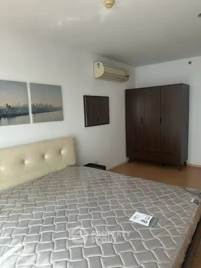 Modern bedroom with stylish wardrobe and air conditioning in a cozy apartment.