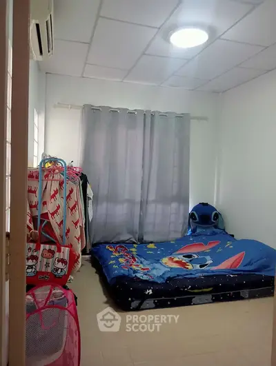 Cozy bedroom with playful decor and ample natural light, perfect for a child's retreat.