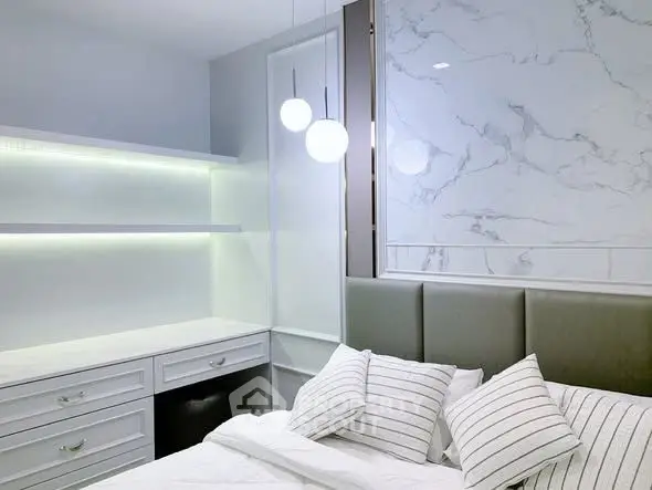 Modern bedroom with elegant marble accent wall and stylish lighting