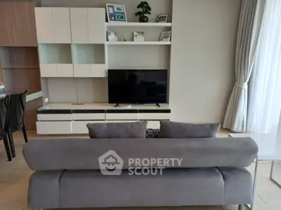 Modern living room with sleek furniture and entertainment center