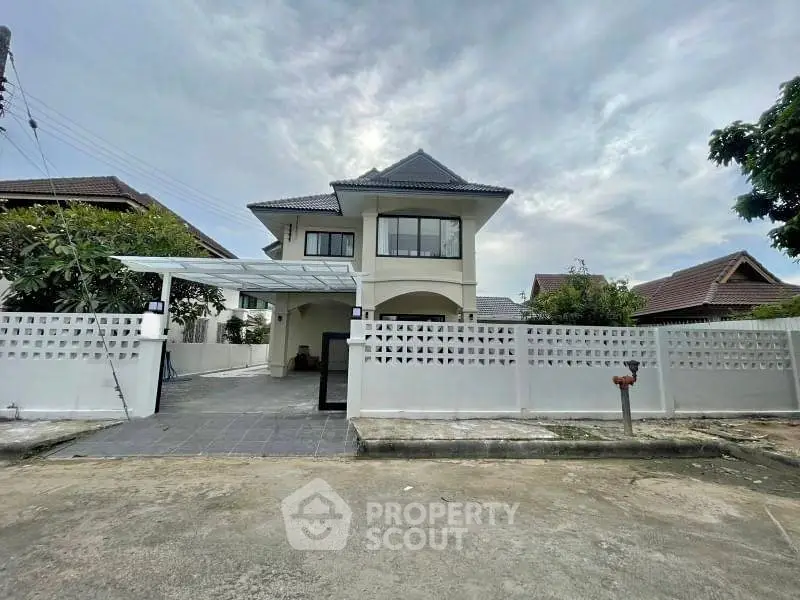 Charming two-story house with modern design and spacious driveway in a serene neighborhood.