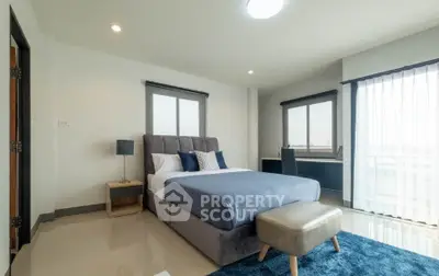 Spacious modern bedroom with elegant decor and natural light