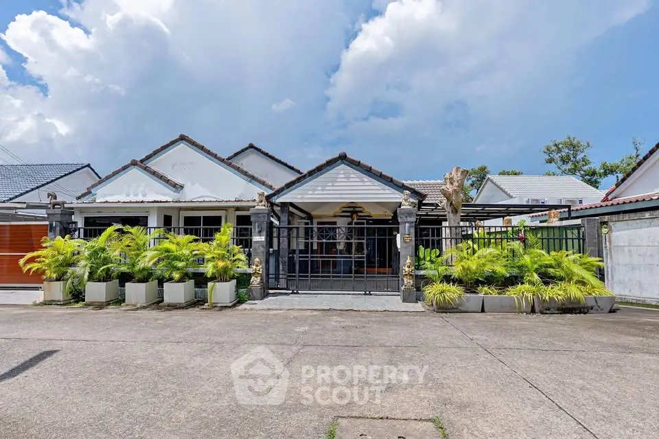 Charming single-story house with lush garden and modern facade, perfect for family living.