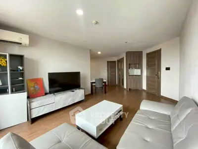 Spacious modern living room with sleek furniture and wooden flooring
