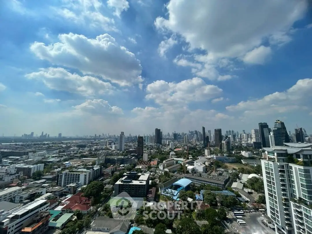 Stunning cityscape view from high-rise apartment with clear blue sky and urban skyline.