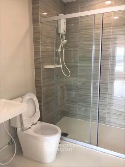 Modern bathroom with glass shower enclosure and sleek fixtures