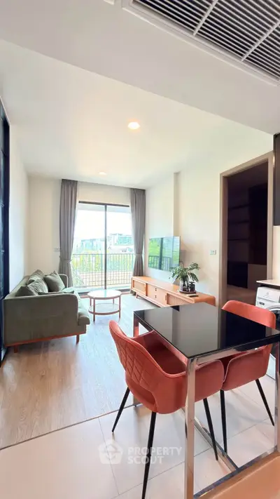 Modern living room with stylish furniture and large window offering a scenic view.