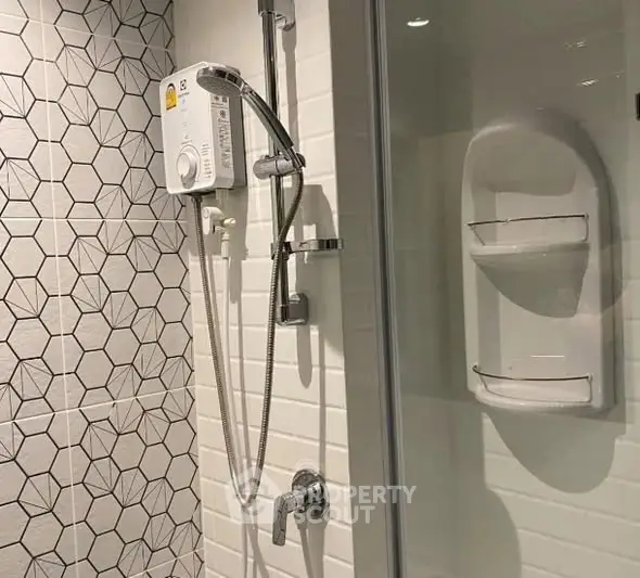 Modern bathroom with stylish geometric tiles and shower unit