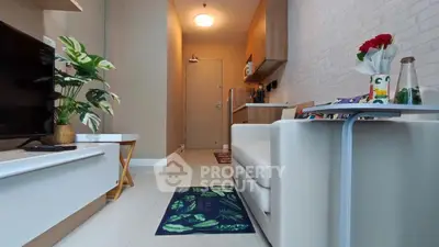 Modern living room with sleek furniture and stylish decor in a cozy apartment setting.
