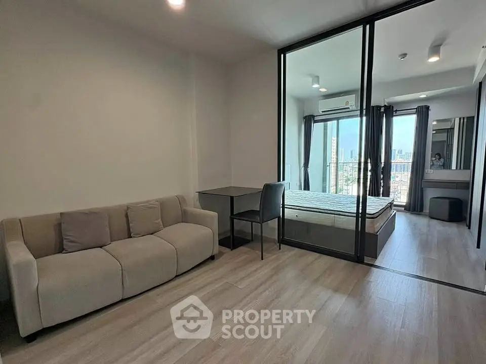 Modern studio apartment with glass partition and city view