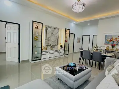 Luxurious modern living room with elegant decor and dining area, featuring a stylish chandelier and marble accents.