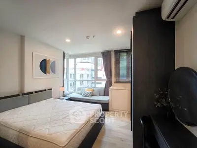 Modern bedroom with large window and stylish decor in urban apartment