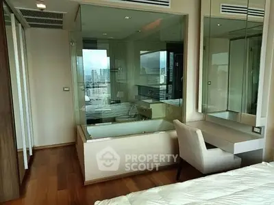 Luxurious bedroom with city view and elegant glass-enclosed bathtub