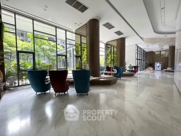 Luxurious modern building lobby with elegant seating and large windows