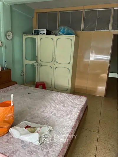 Cozy bedroom with vintage wardrobe and spacious layout, ideal for comfortable living.