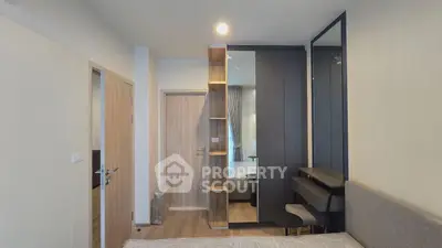 Modern bedroom with stylish decor and built-in storage solutions.