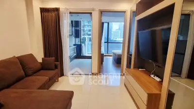 Modern living room with sleek furniture and city view from balcony