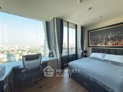 Luxurious bedroom with stunning city view and modern decor, featuring a spacious desk and comfortable bed.