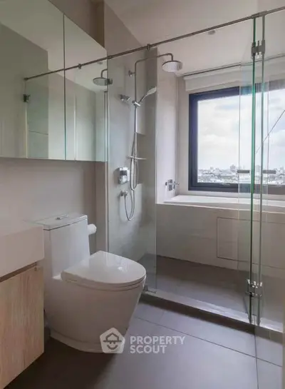 Modern bathroom with glass shower and city view window