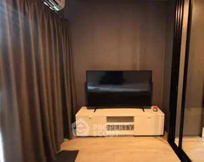 Modern living room with sleek TV setup and elegant curtains