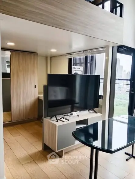 Modern living room with sleek TV stand and city view, perfect for urban living.