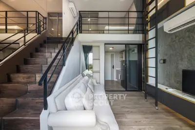 Modern loft-style living room with mezzanine and sleek design