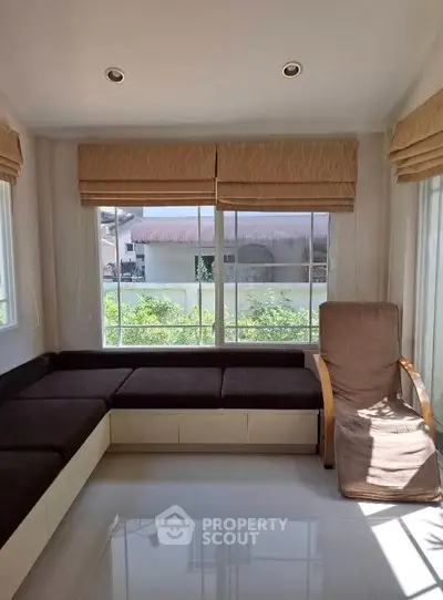Bright living room with large windows and modern seating area