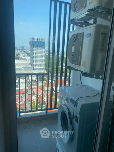 High-rise balcony with city view and laundry appliances, perfect for urban living.