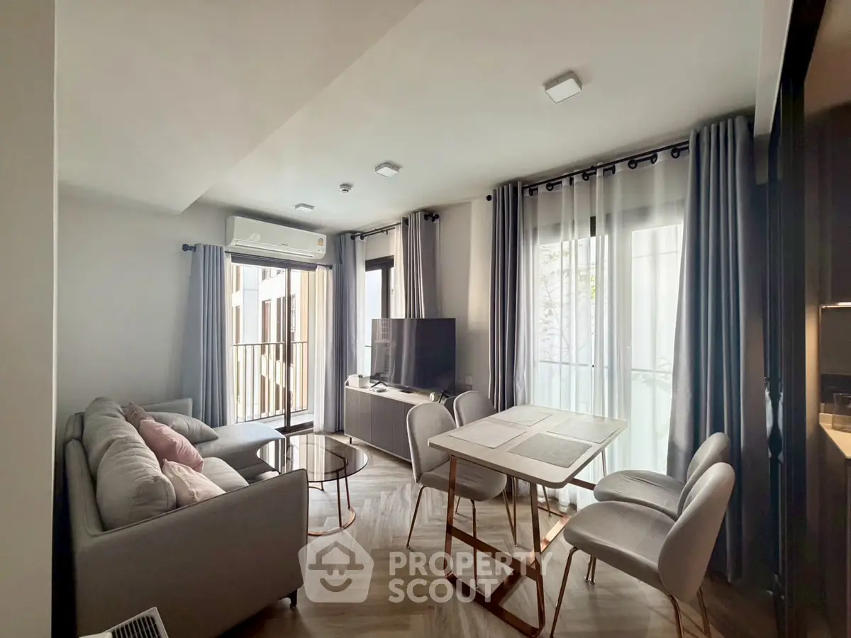 Modern living room with stylish furniture and natural light in a cozy apartment.