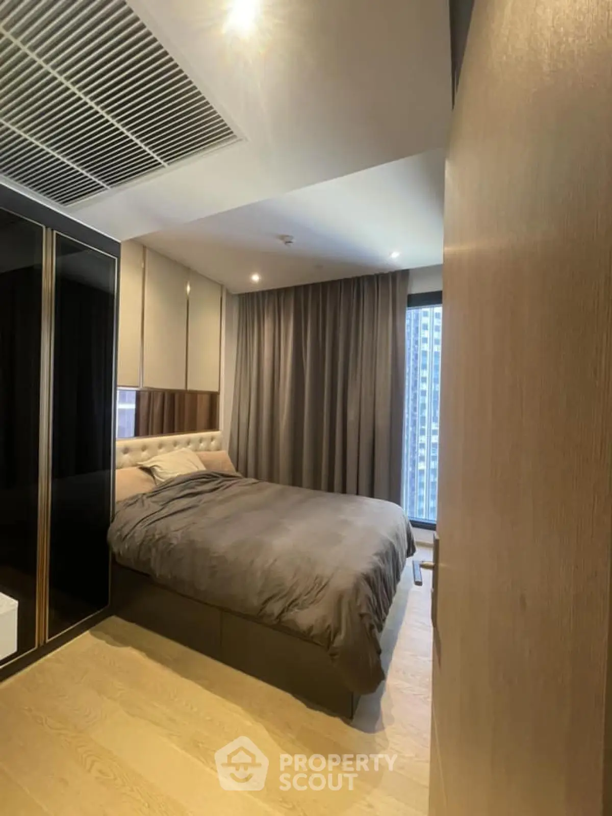 Modern bedroom with elegant design and city view, featuring cozy bed and stylish decor.