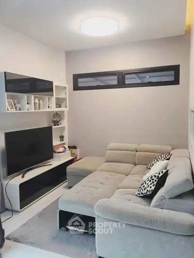 Modern living room with stylish sectional sofa and sleek entertainment unit